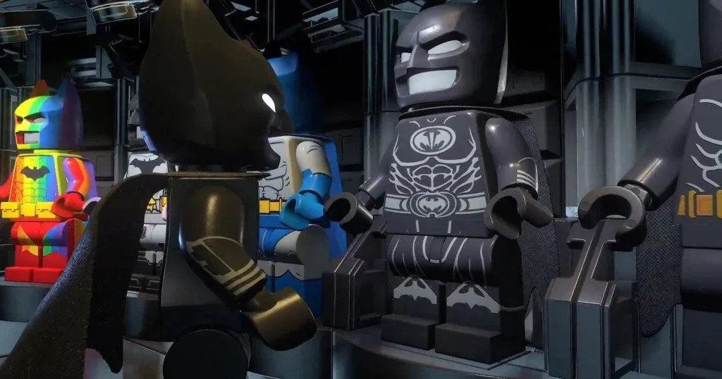 A close-up shot focusing on multiple LEGO Batman minifigures standing in a brightly lit environment with complex structure. One gray suit Batman and others including a colorful rainbow suit and a classic blue and gray suit.